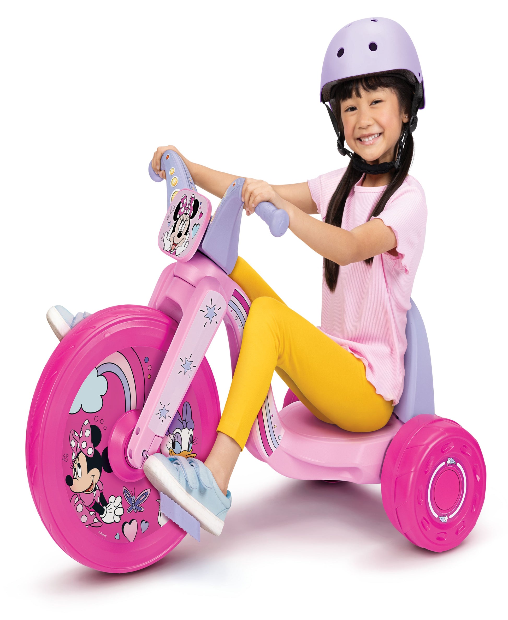 Child modeled by a child on a pink Minnie Mouse trike with large magenta wheels, wearing a purple helmet and holding the handlebar with Minnie character graphic