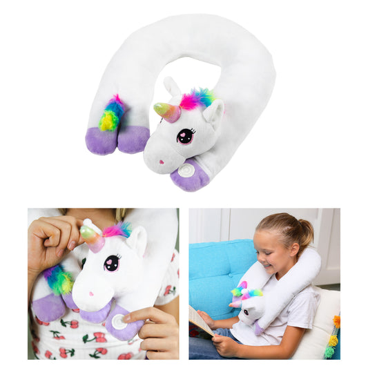 White plush unicorn neck pillow with rainbow mane and horn, purple accents, and vibrating feature; modeled by a child on a blue couch and shown in close-up deta