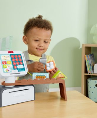 Fisher Price Laugh and Learn Count and Shop Cash Register toy with child playing, includes colorful coins and accesso...
