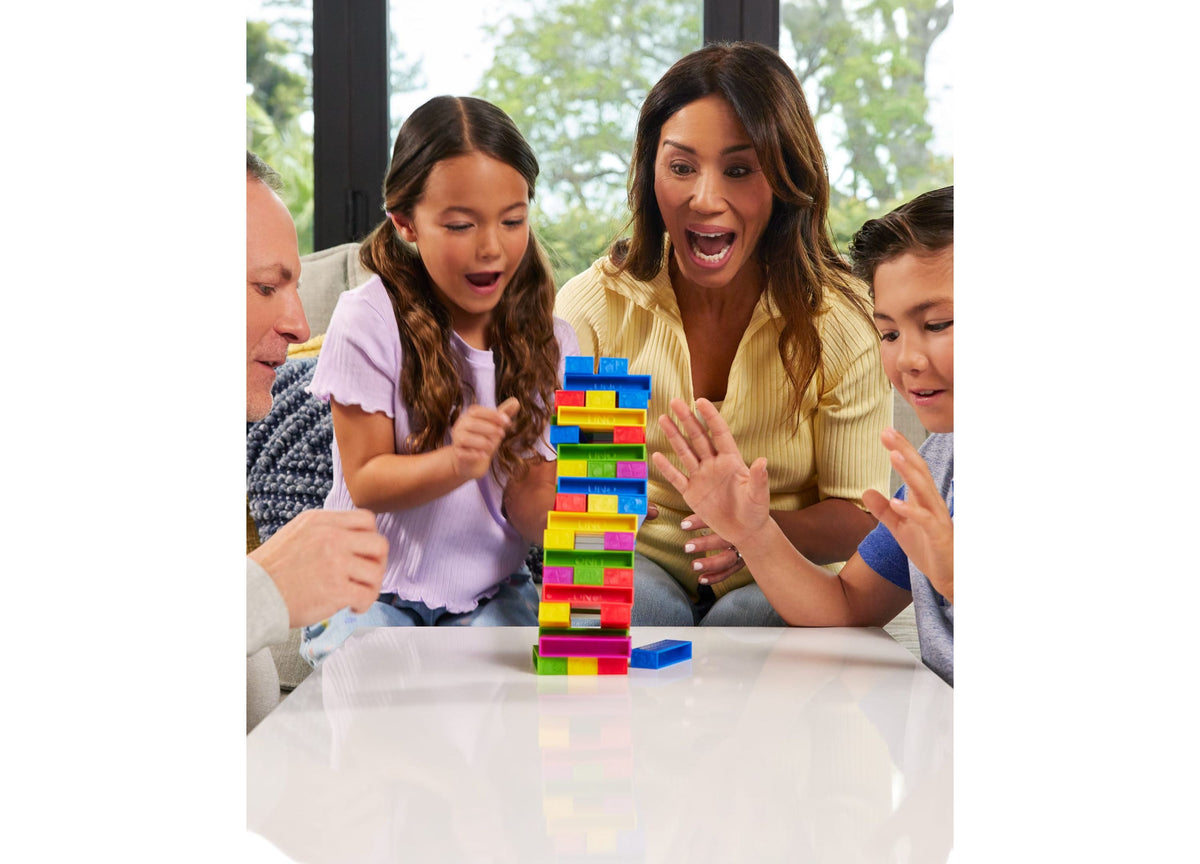UNO Stacko Color & Number Matching Block Game with colorful stacked blocks in red, yellow, blue, and green during fam...