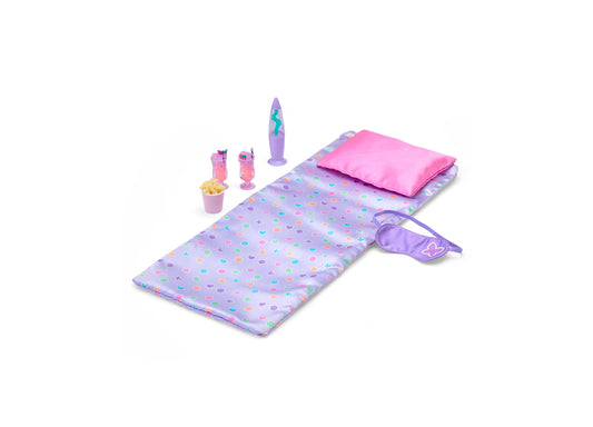 Journey Girls 7-piece glam slumber party playset including sleeping bag with colorful pattern, pink pillow, purple sleep mask, lava lamp, popcorn container, and