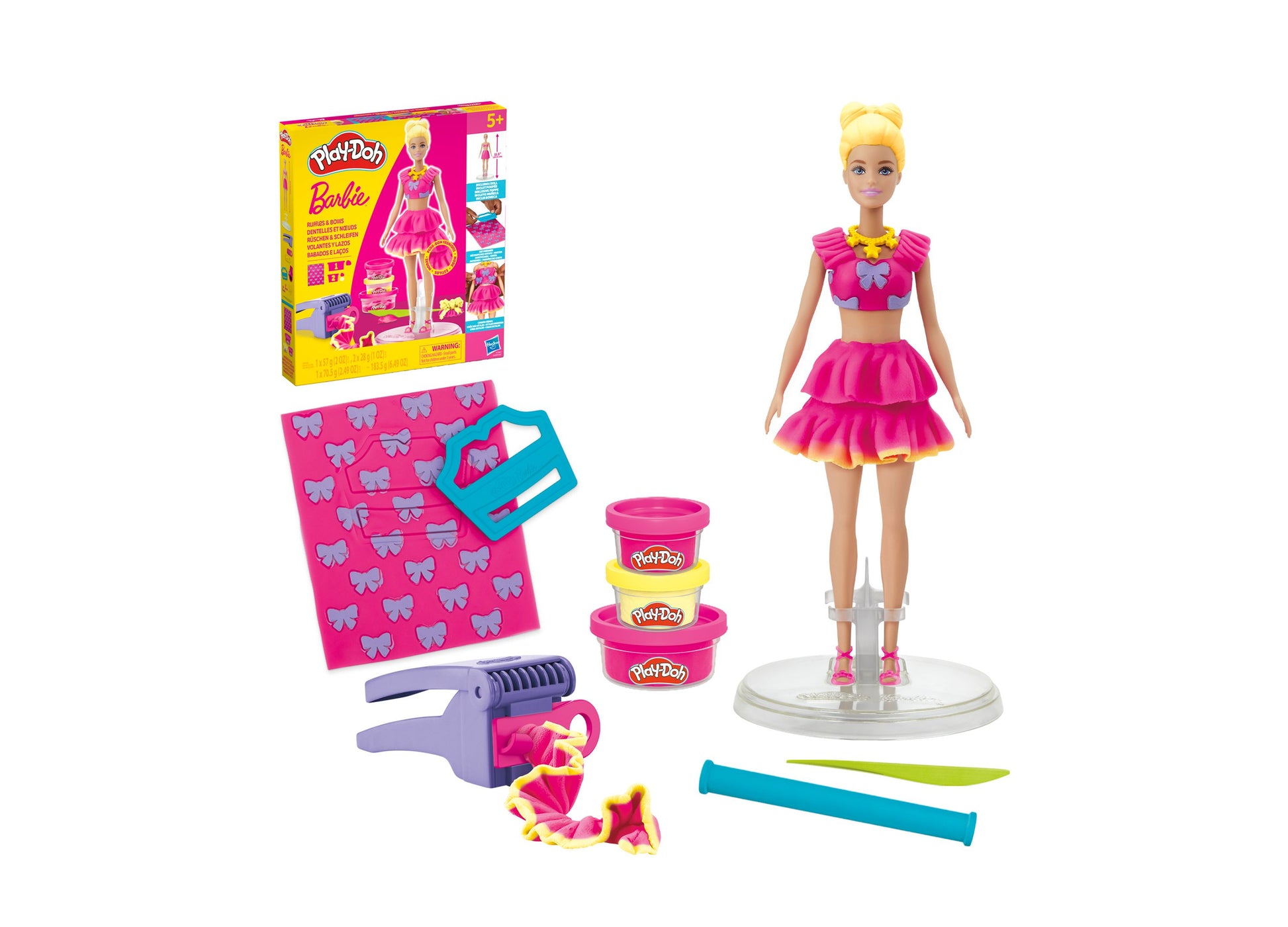Play-Doh Barbie Ruffles and Bows Fashion Designer Set with blonde Barbie doll in pink ruffled skirt, Play-Doh containers, hair styling tool, bow-patterned desig