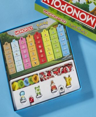 Pokémon Monopoly Edition Board Game with colorful property cards, game pieces, and Pokémon characters displayed