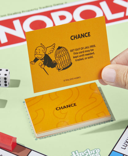 Monopoly Classic Edition board game with yellow Chance card displayed showing jail graphic