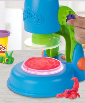 Play-Doh Light and Look Microscope Playset with blue microscope, green handle, pink petri dish, and colorful Play-Doh...