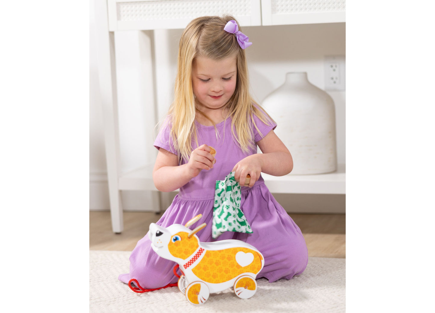 Melissa & Doug Pooping Puppy Toy in orange and white with child playing