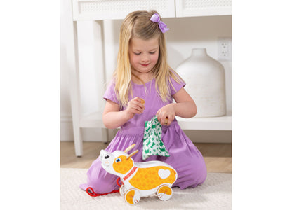 Melissa & Doug Pooping Puppy Toy in orange and white with child playing