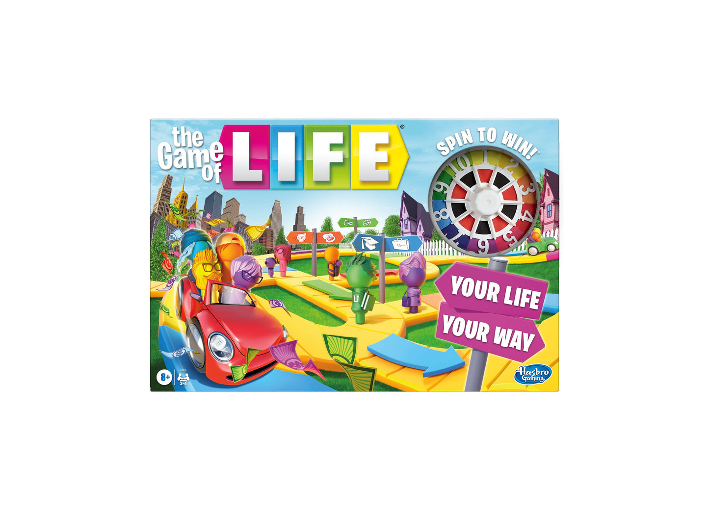The Game of Life board game box showing colorful game board with spinner, game pieces, and cars on a vibrant landscape with buildings and green spaces