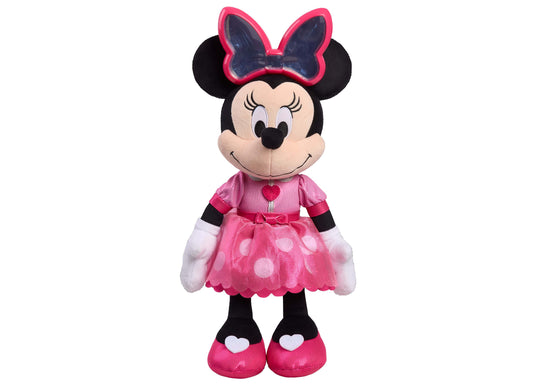 Minnie Mouse plush toy wearing pink bow, pink polka-dot dress with heart detail, white gloves, and pink shoes with heart accents on plain background