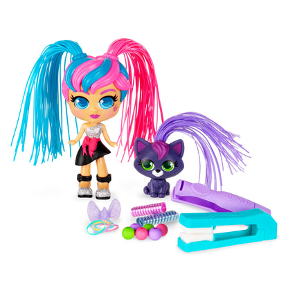 CurliGirls Milli doll with blue and pink pigtail hair, yellow skin, and sparkly outfit, shown with purple cat companion, hair styling tools, colorful balls, and