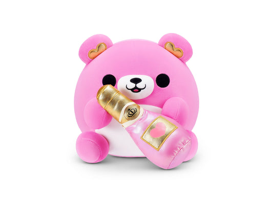 Pink plush bear with white face, black eyes, gold-trimmed ears, holding gold champagne bottle and heart-decorated gift box