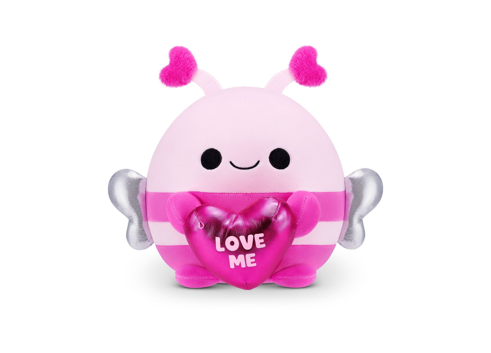 Pink and magenta plush Snackles bumblebee with fuzzy hot pink antennae, silver wings, black dot eyes, closed smile, and heart-shaped accessory reading LOVE ME