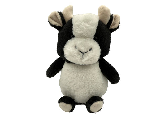 Black and white plush cow with cream-colored face and ears, smiling expression, sitting upright on plain background