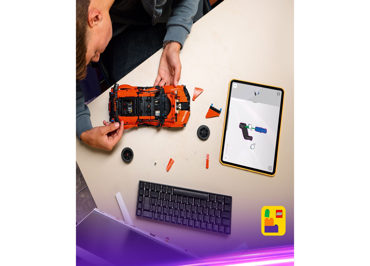 LEGO Technic Bugatti Chiron Pur Sport orange hypercar model with disassembled parts and building instructions on tablet