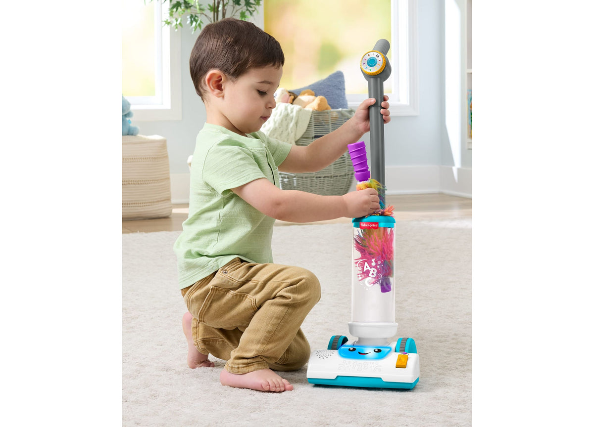 Fisher-Price Laugh & Learn 2-in-1 Vacuum learning toy with toddler playing, featuring purple handle and colorful base