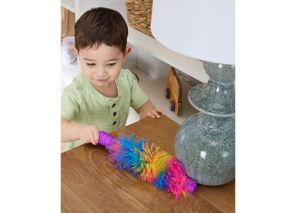 Toddler in green shirt using Fisher-Price Laugh & Learn 2-in-1 Vacuum with colorful rainbow bristles
