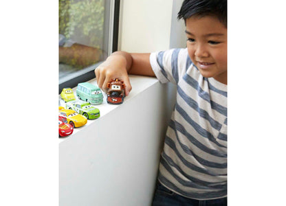 Child playing with Disney Pixar Cars Mini Racers Die-Cast Vehicle 10-Pack, featuring colorful miniature car character...