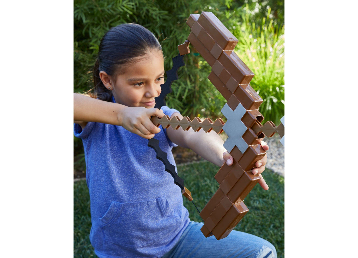 Girl holding brown Minecraft Ultimate Bow and Arrow toy with blue diamond detail