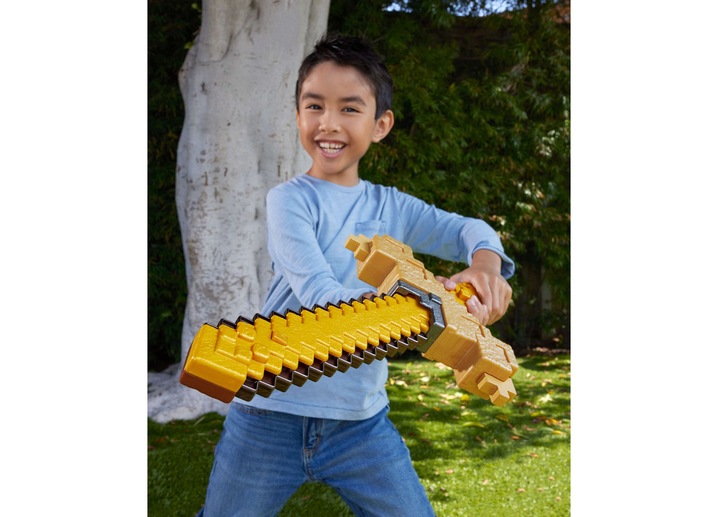 Boy holding gold Minecraft Click and Switch 2-in-1 sword and pickaxe toy