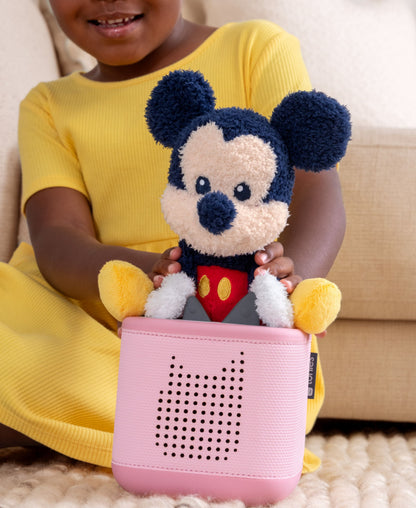 Cuddle Tonies Mickey Mouse plush in child's hands with pink speaker below