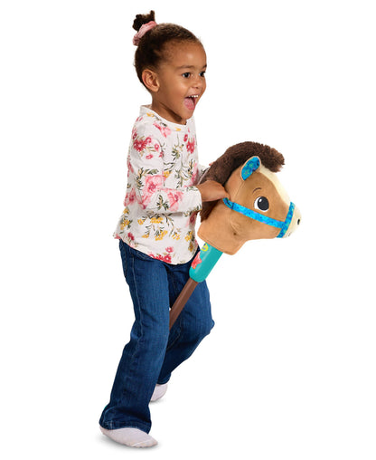 VTech Gallop & Giggle Horse with brown plush body and blue bridle, held by smiling child