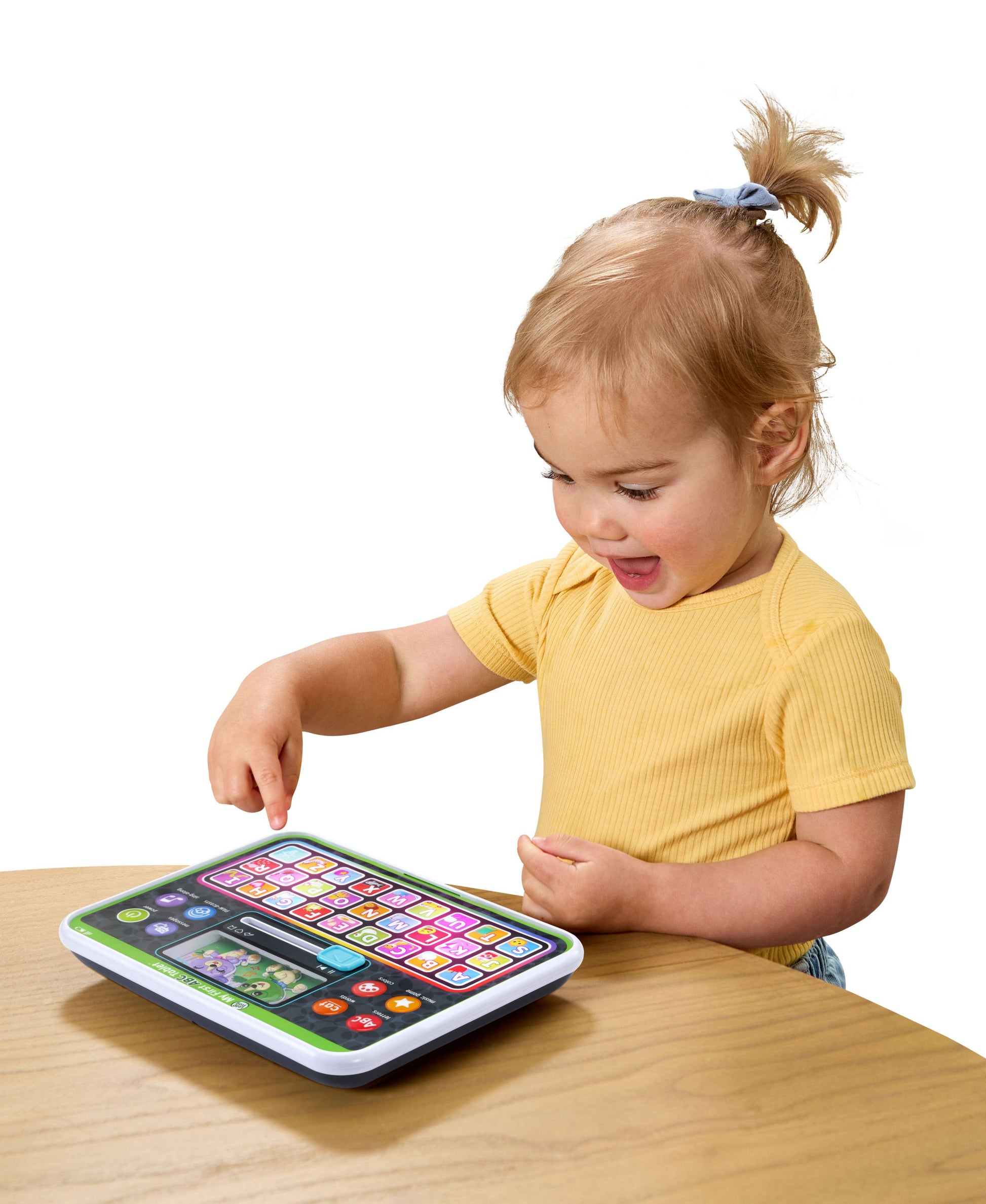Leapfrog My First ABC Tablet in green and white with colorful letter buttons, toddler playing