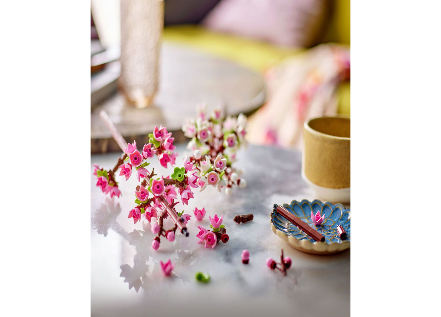 LEGO Cherry Blossoms Building Set 40725 with pink flowers and green stems displayed on white surface