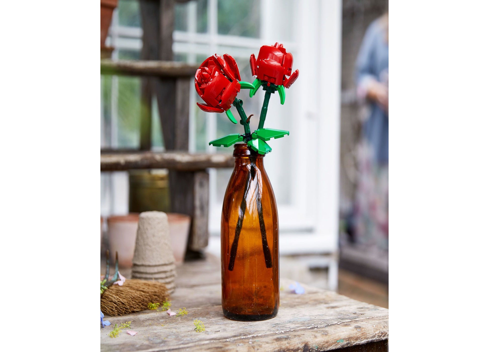 LEGO Roses Botanical Collection red flower building set displayed in amber glass bottle