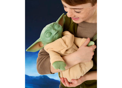 Star Wars Action Buddy Grogu plush toy in green with tan robe, held by child