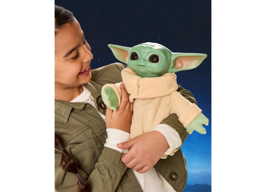 Star Wars Action Buddy Grogu plush toy with green skin and tan robe held by child