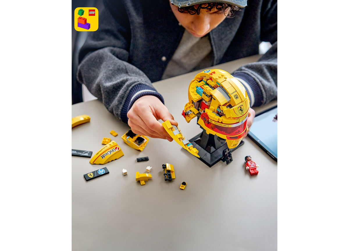 LEGO Scuderia Ferrari HP Lewis Hamilton Helmet Building Set in yellow and red, displayed with assembled pieces