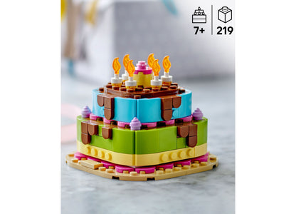 LEGO Birthday Party Cake Building Set 40815 with colorful blue, green, and yellow tiers, brown frosting details, and ...