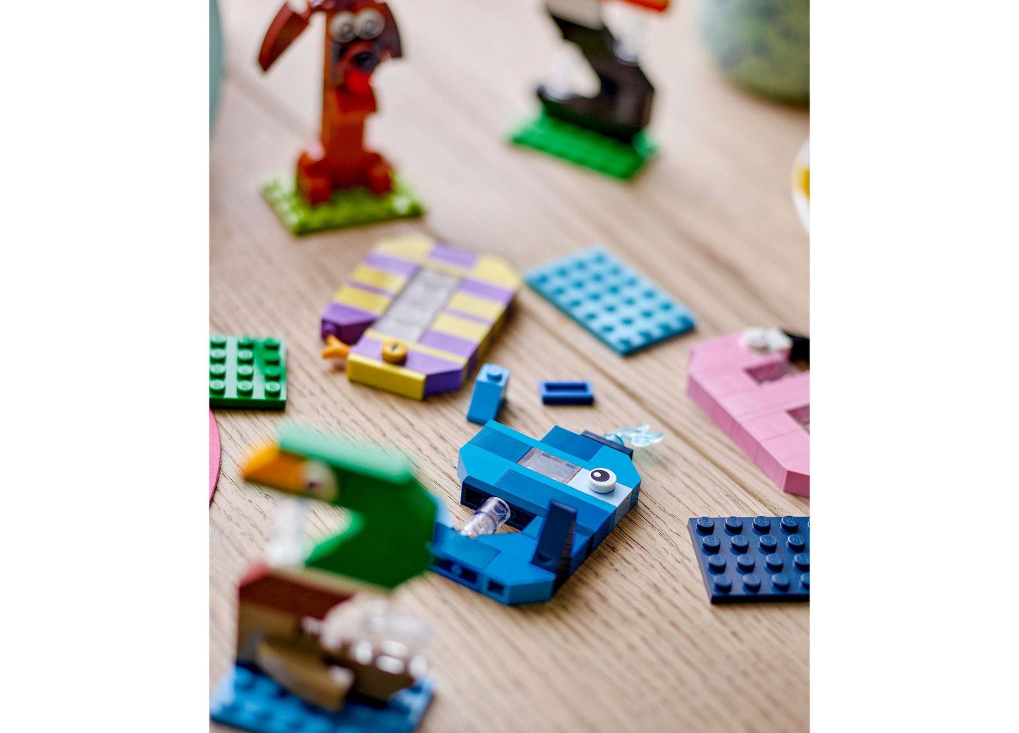 LEGO Birthday Numbers Party Decor Set 40807 with colorful brick pieces and animal figures on wooden surface