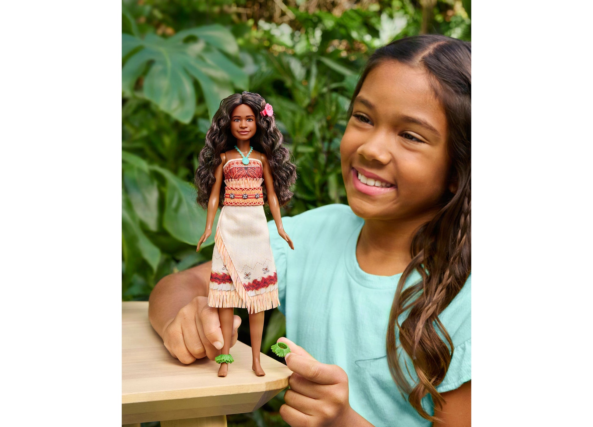 Disney Princess Moana Fashion Doll with removable outfit, accessories, and long dark hair with flower