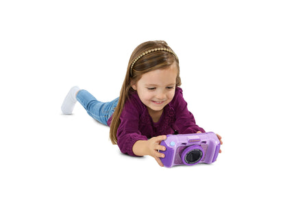 VTech KidiZoom purple digital camera with rotating lens held by smiling child