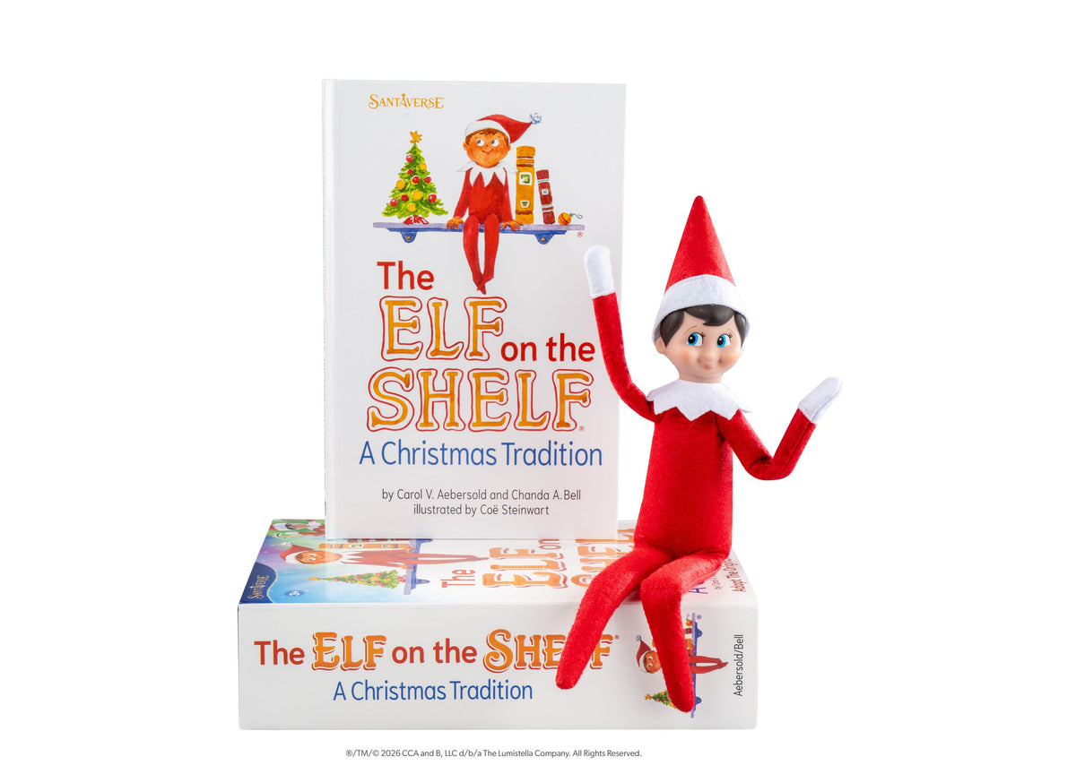 Elf on the Shelf Scout Elf Boy figure in red suit with white collar and red-and-white hat, posed next to storybook an...