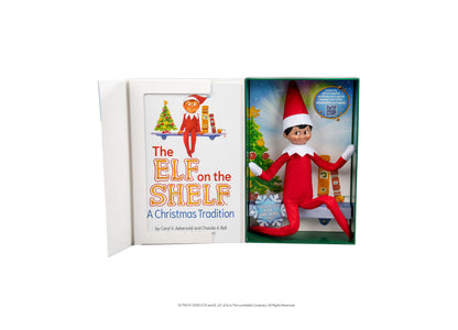 Elf on the Shelf Scout Elf Boy figure with red suit and hat next to storybook in boxed set