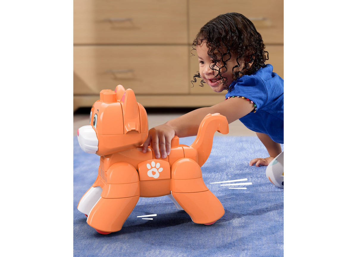 Child playing with orange Mega Bloks Fisher-Price Rolling Kitten 3-in-1 building set on blue mat