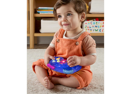 Fisher Price Laugh and Learn Controller in blue and pink, held by toddler in orange outfit