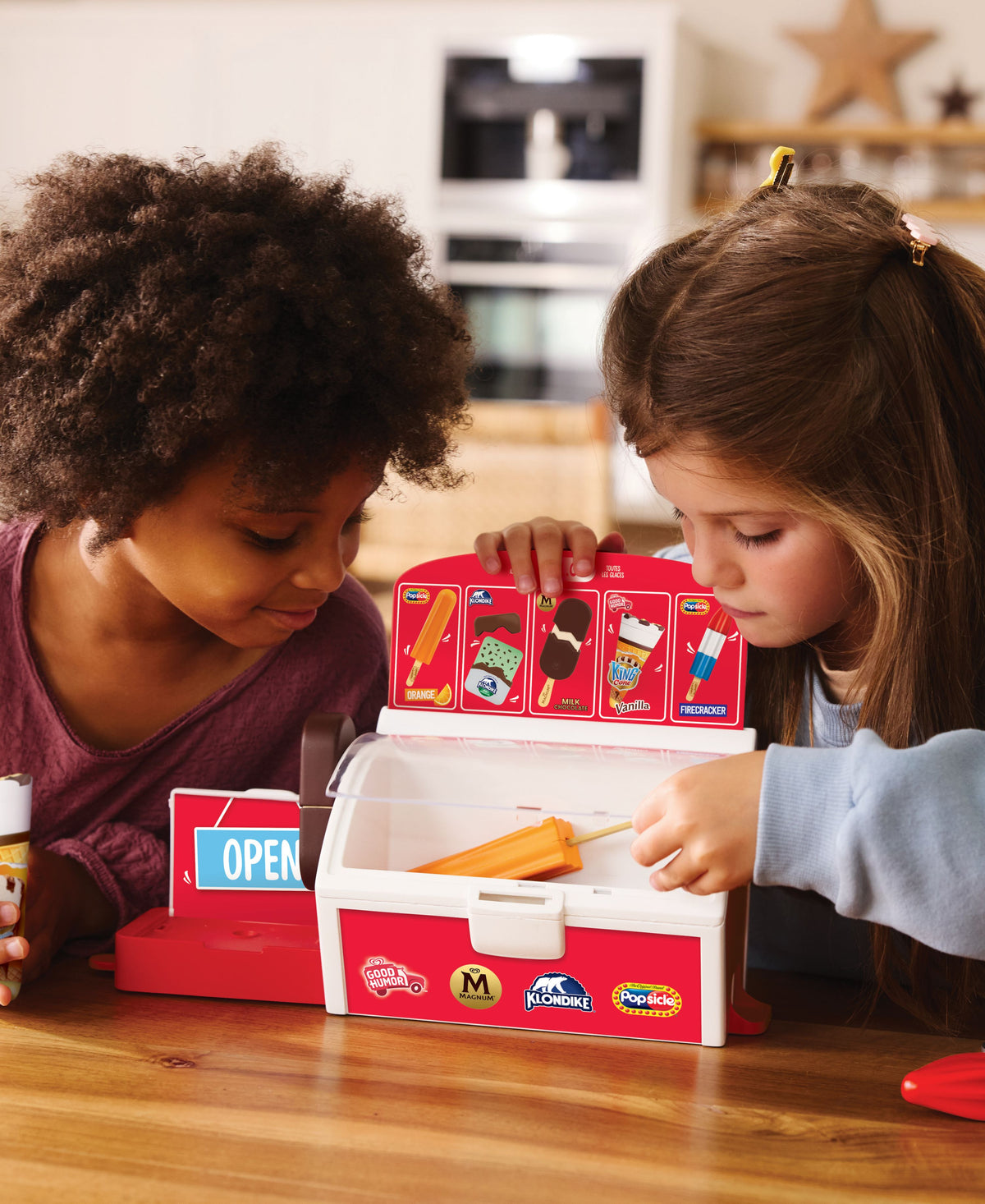 Casdon Ice Cream Shop playset with red freezer case, menu board, and play ice cream treats in red and white