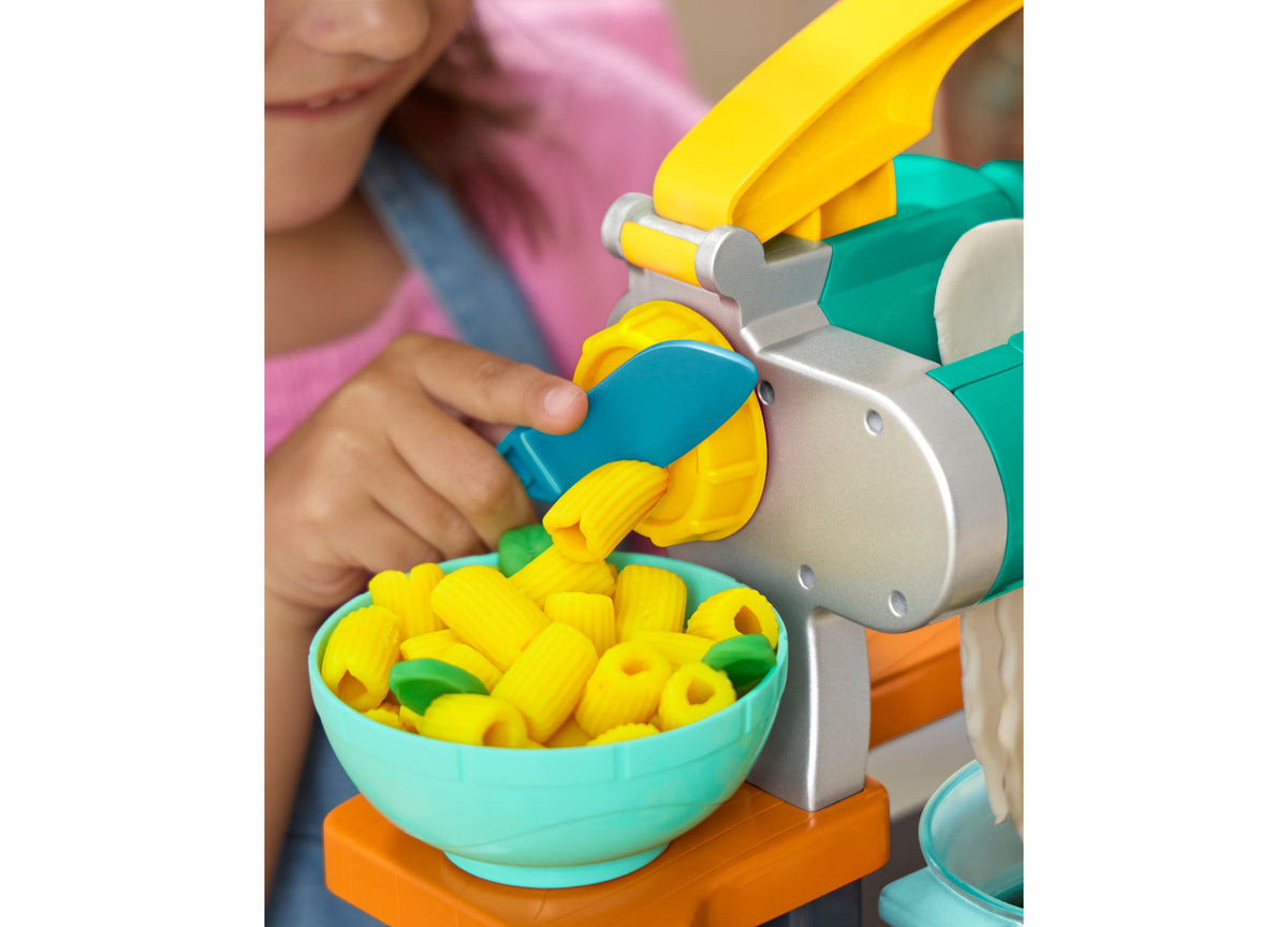 Play-Doh Super Sizzlin' Kitchen Playset with pasta maker dispensing yellow pasta into turquoise bowl