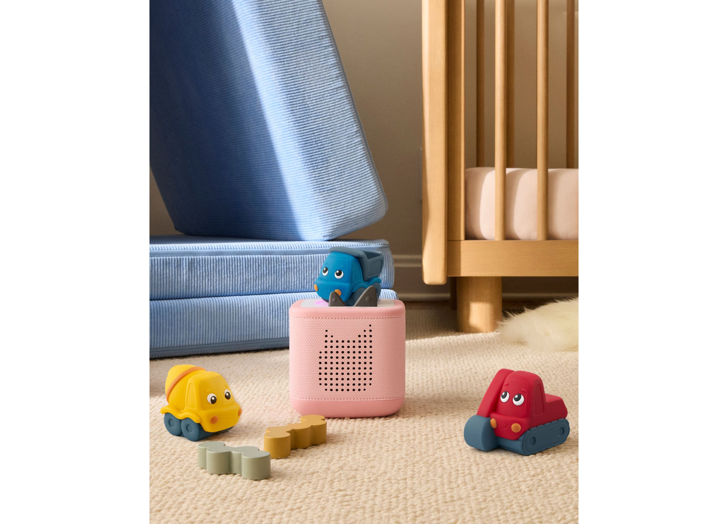 Tonies My First Tonies Construction Set with yellow, blue, and red toy vehicles on beige carpet