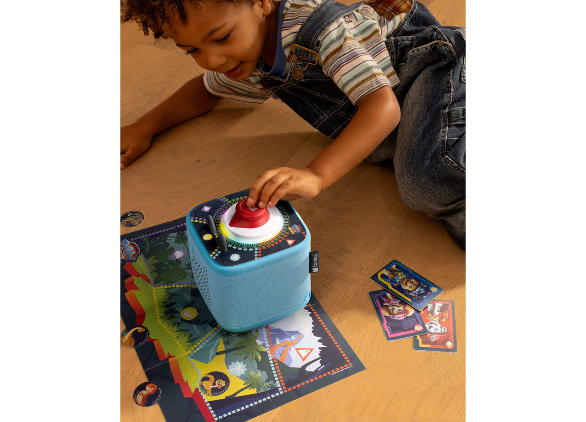 Tonies Tonieplay PAW Patrol board game with blue speaker and red button, child playing on colorful game mat
