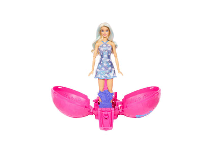 Barbie Roll & Reveal Pop Star doll with light blue hair in purple sequin dress, standing on pink rolling ball toy base