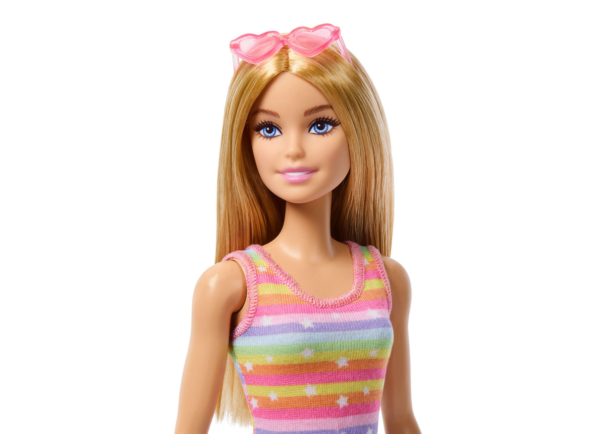 Barbie doll with long blonde hair wearing rainbow striped tank top and pink heart-shaped sunglasses