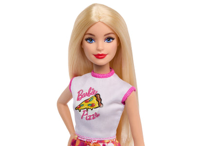 Barbie doll with long blonde hair wearing white and pink pizza-themed shirt