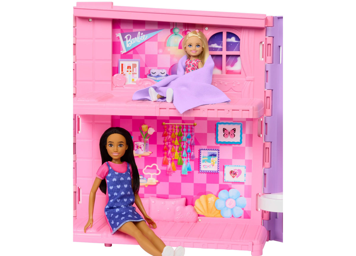 Barbie Weekend Escape Foldable Dollhouse with four pink play areas, Barbie doll in bedroom, and kitten in kitchen