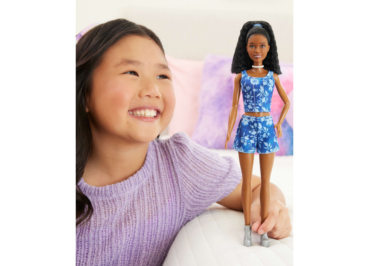 Barbie Fashionistas Style #248 doll with wavy black hair, pearl choker, and blue floral crop top and shorts