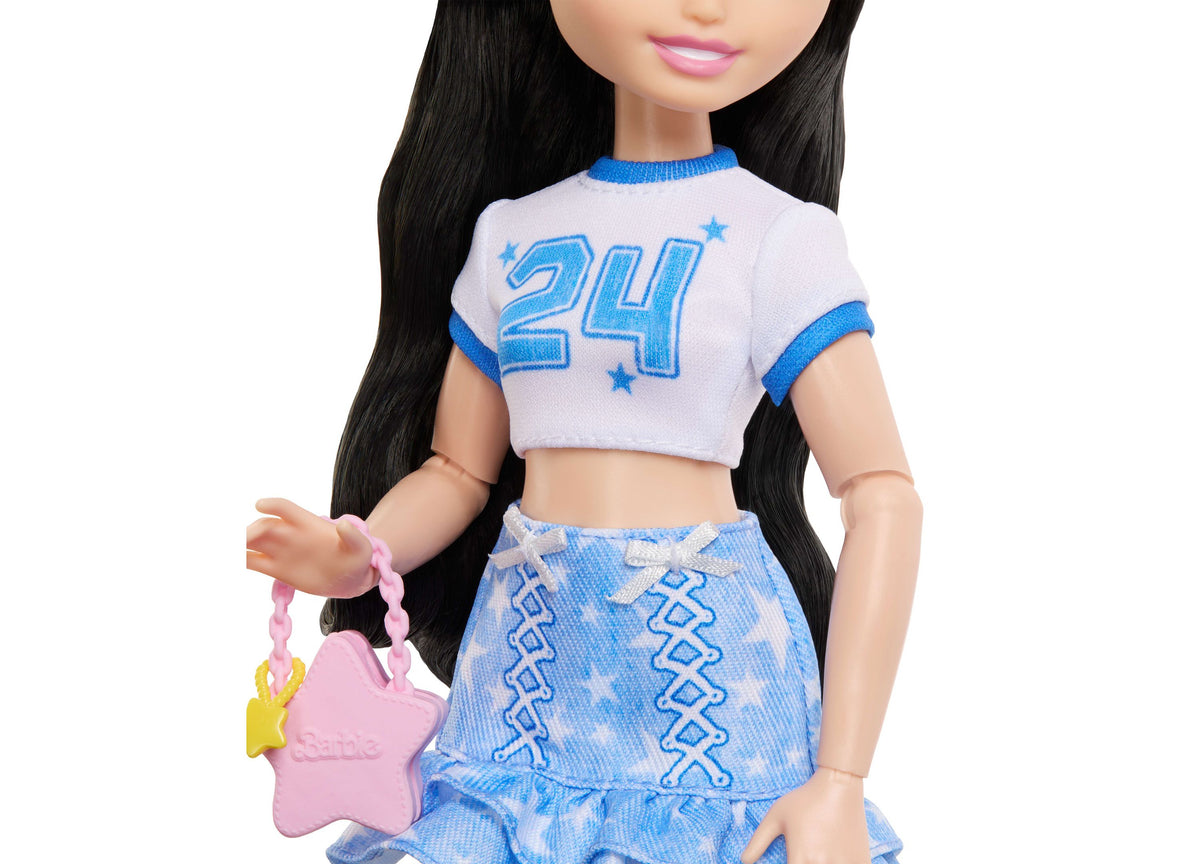Barbie Dream Besties Renee doll with black hair wearing blue and white numbered crop top and skirt, holding pink star...