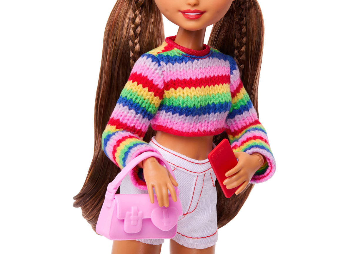 Barbie Dream Besties Weekend Getaway Teresa doll wearing rainbow striped sweater and white shorts, holding red phone ...